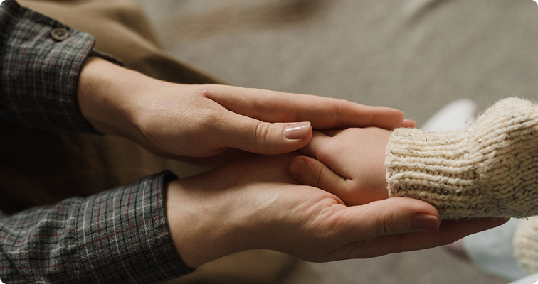 Parent holding child’s hand